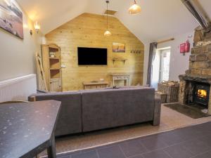 a living room with a couch and a fireplace at Dovecote Cottage in Scarborough