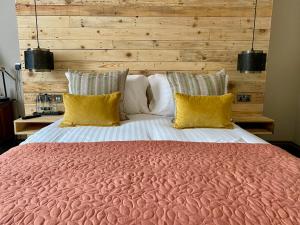 a bedroom with a large bed with yellow pillows at The Southern Belle in Brighton & Hove