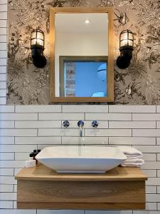a bathroom with a sink and a mirror at The Southern Belle in Brighton & Hove