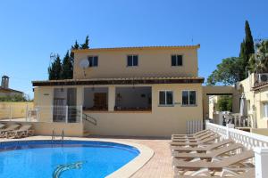 a villa with a swimming pool in front of a house at Casa Robion in Godelleta