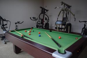 a pool table in a gym with exercise bikes at African Moon Corporate House in Kempton Park