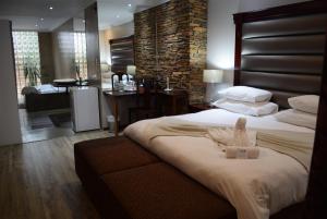 a hotel room with a bed with a robe on it at African Moon Corporate House in Kempton Park +27 photos