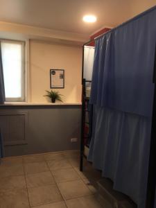 a room with a blue curtain and a window at Travel Inn Достоевская in Moscow