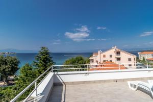 a balcony with a view of the ocean at Maestral Apartments in Malinska