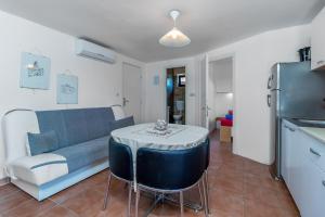 a living room with a couch and a table at Maestral Apartments in Malinska