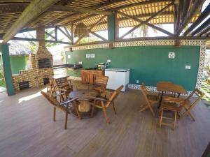 a large room with a table and chairs and a fireplace at Pousada Barra Nova Praiamar in Cascavel