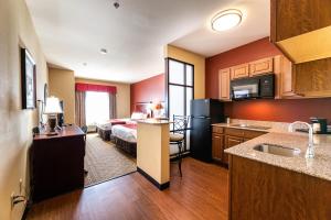 a hotel room with a bed and a kitchen at Comfort Suites - Lake Worth in Fort Worth