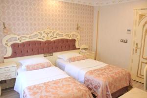 Postel nebo postele na pokoji v ubytování Nayla Palace Hotel-Special Category