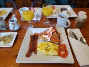 a plate of breakfast food on a wooden table at Cleveland House Inn in Newport