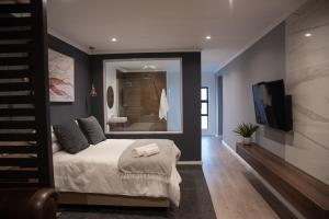 a bedroom with a bed and a large mirror at The Royal Bryanston in Johannesburg