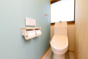 a bathroom with a toilet and two rolls of toilet paper at BEYOND HOTEL Takayama 4th - Vacation STAY 99852 in Takayama