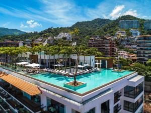 a hotel with a pool on top of a building at PIER 57- 309 Beautiful 2 BR Condo in Romantic Zone in Puerto Vallarta