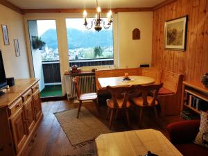 a dining room with a table and a large window at Alpenblick 30 in Bad Mitterndorf