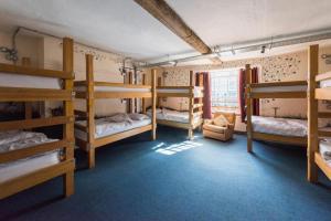 a room with several bunk beds in a building at The Full Moon Backpackers in Bristol