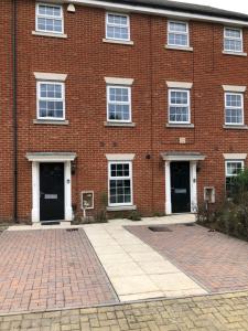 a brick building with two doors and a brick courtyard at San Pedro Lodge Rochester in Rochester +26 photos