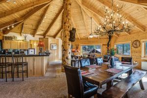 a dining room and kitchen with a wooden ceiling at Snow Circle Lodge in Pagosa Springs
