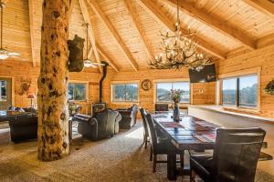 a dining room with a large wooden table and chairs at Snow Circle Lodge in Pagosa Springs