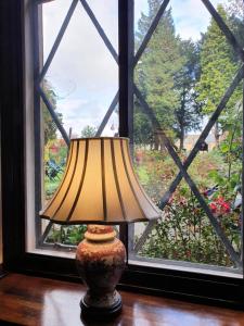 a lamp sitting on a table in front of a window at Stow Lodge Hotel in Stow on the Wold