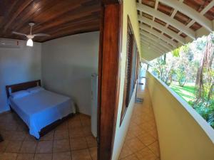 a bedroom with a bed in a room with a ceiling at Pousada Recanto Itaguá in Ubatuba +75 photos