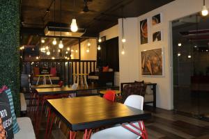 a dining room with tables and chairs and lights at Hotel Florencia Poza Rica in Poza Rica de Hidalgo