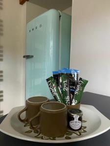 a plate with two coffee mugs on a table at Bondgate Holiday Cottage in Durham