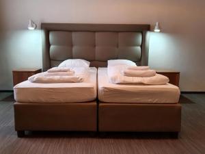 two beds in a room with two pillows on them at Kamienica Bankowa Residence in Poznań