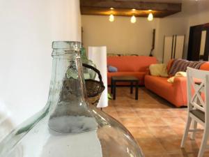 a glass bottle sitting on a table in a living room at La Campana de Arriba in La Guancha