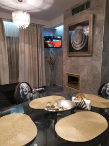 a dining room with three tables and a fireplace at Мирков Дар in Bansko