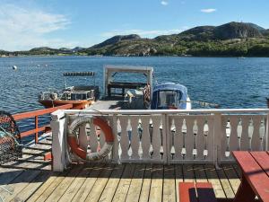 a boat on a dock on a body of water at 6 person holiday home in Oksvoll in Oksvoll