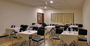 a room with tables and chairs with bottles on them at Vishal Lords Inn Gir Forest in Mendarda