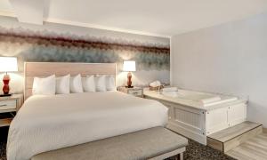 a bedroom with a bed and a bath tub at Hallmark Resort - Newport in Newport