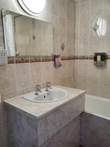 a bathroom with a sink and a mirror at Stow Lodge Hotel in Stow on the Wold