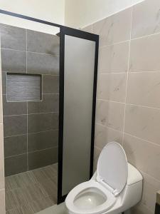 a bathroom with a toilet and a shower stall at Hotel Morelos Colima in Colima