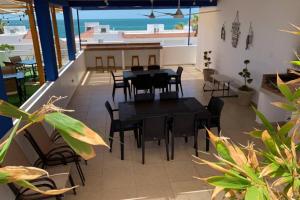 a patio with a table and chairs and the ocean at Diamante Joyas Del Mar Bahia de Kino in Bahía Kino