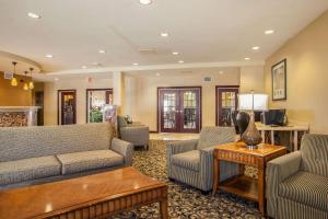 a living room with a couch and chairs and a table at Comfort Suites Bloomington I-55 and I-74 in Bloomington