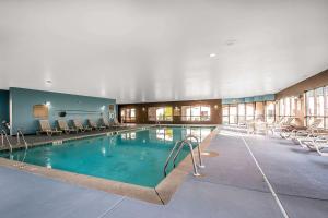 a large swimming pool with chairs in a building at Clarion Inn Elmhurst - Oak Brook near I-88, I-290, I-294 in Elmhurst