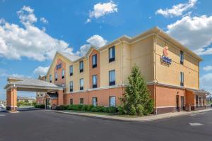 a hotel with a sign on the side of a building at Comfort Inn & Suites Muncie Near University in Muncie