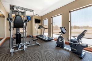 a gym with treadmills and exercise equipment and windows at Comfort Inn & Suites Muncie Near University in Muncie