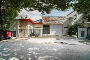 a house with a motorcycle parked in front of it at Cityzen Renon Hotel in Denpasar