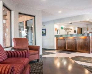 a lobby with a waiting room with a couch and chair at Quality Inn in Hudsonville