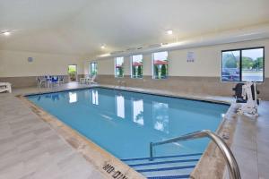 a large swimming pool with blue water in a building at Comfort Inn & Suites in Taylor