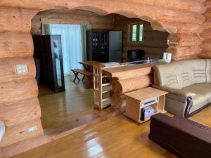 a living room in a log cabin with a couch and a table at Ise Forest villa - Vacation STAY 9557 in Ise