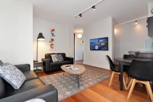 a living room filled with furniture and a couch at Ridge Apartment Hotel in Brisbane