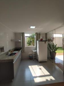 a kitchen with a white refrigerator in a room at Casa em Capitolio in Capitólio