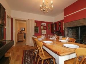 a dining room with a table with chairs and a fireplace at Dale House in Cockermouth +14 photos