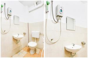 a bathroom with two sinks and a toilet and a shower at OYO 89615 T Family Hotel in Klang