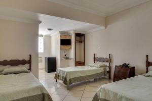 A bed or beds in a room at Hotel Estrela Do Vale