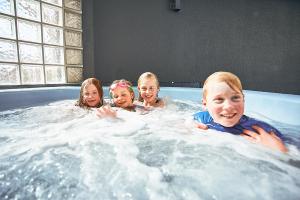 a group of children swimming in a hot tub at Salamanca Inn in Hobart