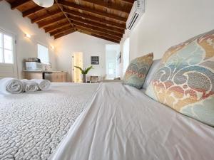 a large bed with pillows on it in a room at Casa Coral in Miami