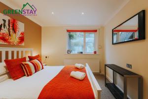 a bedroom with a large bed and a window at "The Garden Apartment Newquay" by Greenstay Serviced Accommodation - Beautiful 2 Bed Apartment With Parking & Outside Terrace, Close To Beaches, Shops & Restaurants -Perfect For Families, Couples, Small Groups & Business Travellers in Newquay